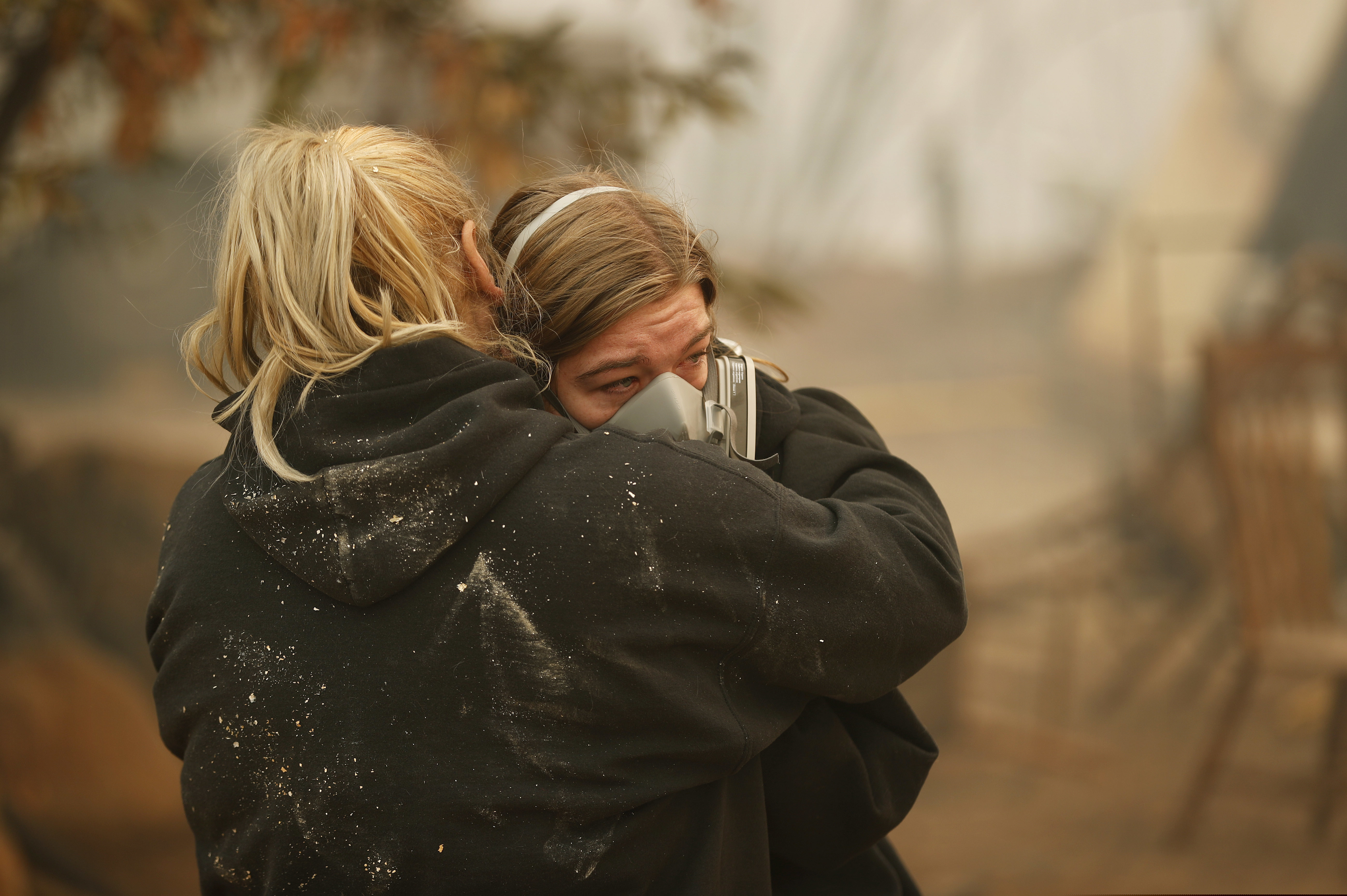 (John Locher | The Associated Press) Krystin Harvey, left, comforts her daughter Araya Cipollini at the remains of their home burned in the Camp Fire, Saturday, Nov. 10, 2018, in Paradise, Calif. The blaze that started Thursday outside the hilly town of Paradise has grown and destroyed more than 6,700 buildings, almost all of them homes, making it California's most destructive wildfire since record-keeping began. But crews have made gains and the fire is partially contained, officials said Saturday.