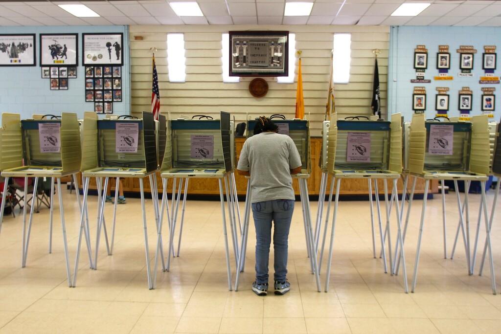 FILE - In this July 21, 2015, file photo, Carolyn Yazzie fills in her ballot at the Shiprock Chapter House in Shiprock, N.M., during the Navajo Nation's referendum election to decide the language qualifications for future leaders. Navajos who once worried they'd have to drive hours to cast their ballots in Utah say a new settlement is a step forward as tribes challenge what they call discriminatory voting practices around the United States. The American Civil Liberties Union of Utah said Thursday, Feb. 22, 2018, the settlement that requires tribal-accessible polling places and Navajo-language help is a victory for voting rights after a switch to mail-in voting left behind native voters. (Jon Austria/The Daily Times via AP, File)