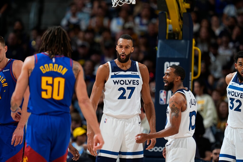 Minnesota Timberwolves center Rudy Gobert (27) and Minnesota Timberwolves guard Mike Conley (10) in the second half of Game 1 of an NBA basketball second-round playoff series Saturday, May 4, 2024, in Denver. (AP Photo/David Zalubowski)
