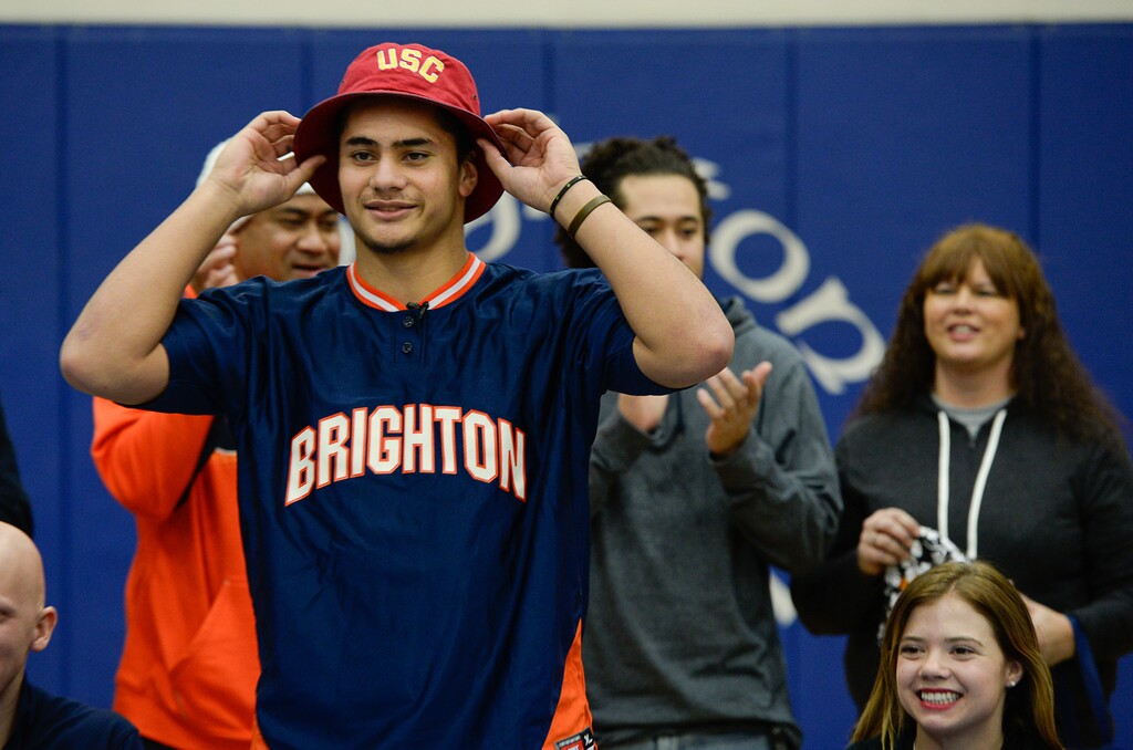 Francisco Kjolseth | The Salt Lake Tribune
Brighton's five-star linebacker Osa Masina, regarded as the top-rated college prospect coming out of Utah, picks up the USC hat as he reveals his school of choice to attend and play during a school assembly held in his honor and other student athletes receiving school scholarships.