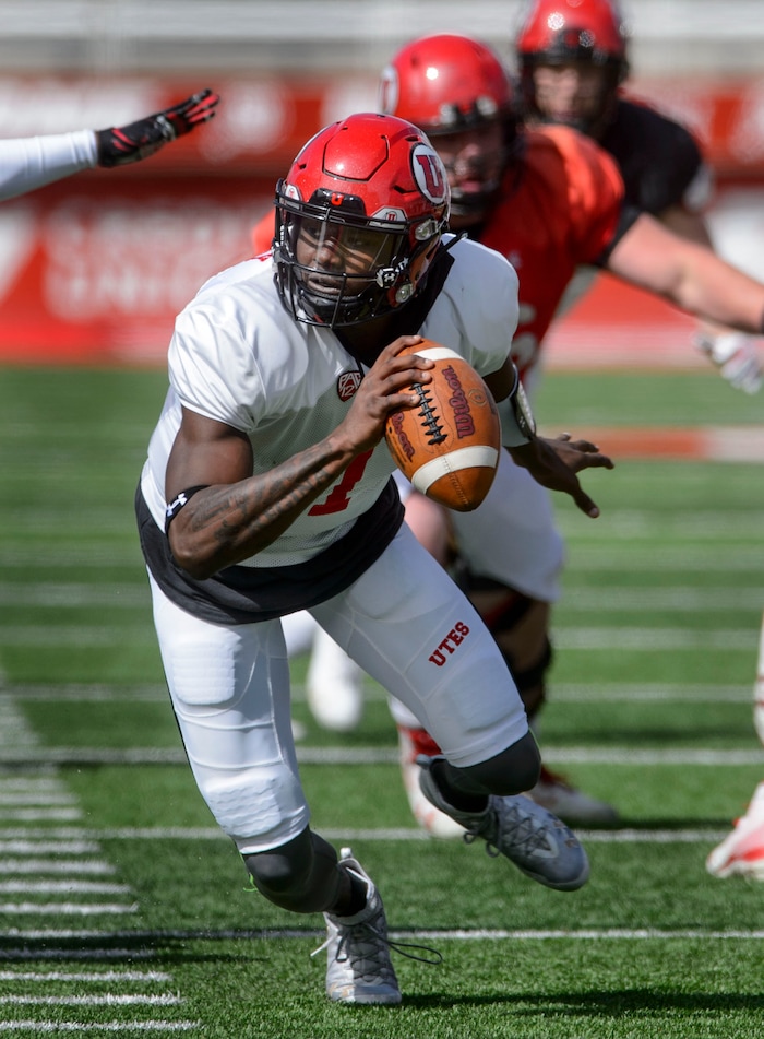 (Steve Griffin  |  The Salt Lake Tribune) Utah quarterback Tyler Huntley scrambles out of trouble during the University of Utah football team's first scrimmage at Rice-Eccles Stadium in Salt Lake City Friday March 30, 2018.