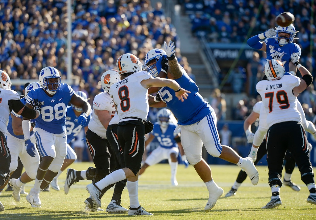 (Leah Hogsten  |  The Salt Lake Tribune) Brigham Young Cougars defense pressures Idaho State Bengals quarterback Matt Struck (8)as Brigham Young University takes on Idaho State, Saturday, Nov. 16, 2019 at LaVell Edwards Stadium. 