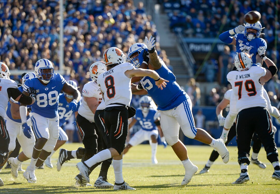 (Leah Hogsten  |  The Salt Lake Tribune) Brigham Young Cougars defense pressures Idaho State Bengals quarterback Matt Struck (8)as Brigham Young University takes on Idaho State, Saturday, Nov. 16, 2019 at LaVell Edwards Stadium.