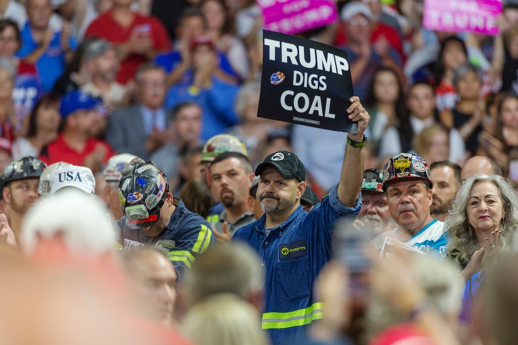 A group of coal miners are seen before President Trump takes the stage at a rally by President Trump in support of the Senate candidacy of Attorney General Patrick Morrisey, Tuesday, Aug. 21, 2018, at the Charleston Civic Center in Charleston, W.Va.  (Craig Hudson/Charleston Gazette-Mail via AP)