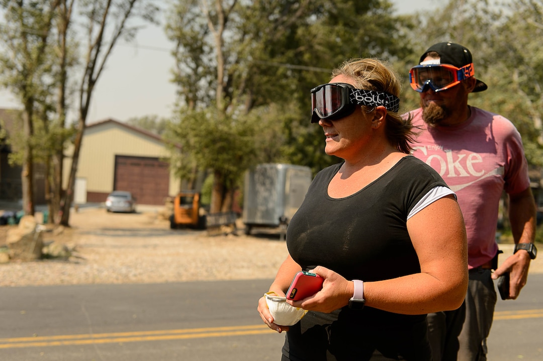 (Trent Nelson | The Salt Lake Tribune)  Jake and Maryann Wayman wear goggles to deal with the smoke after a fire nearly made it to their Uintah home, Tuesday September 5, 2017.