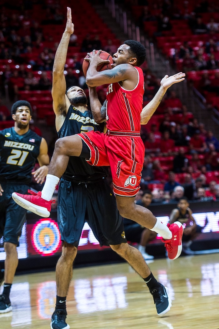 (Chris Detrick  |  The Salt Lake Tribune)  Utah Utes guard Justin Bibbins (1) shoots past Missouri Tigers guard Kassius Robertson (3) during the game at the Jon M. Huntsman Center Thursday, November 16, 2017.   