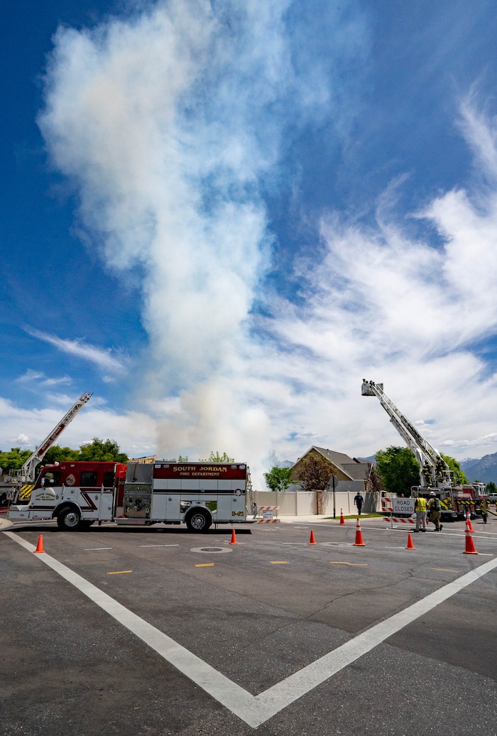 (Francisco Kjolseth | The Salt Lake Tribune) South Jordan tears down a house where an owner kept a stockpile of explosives, as firefighters help burn off residual explosives that remained in the basement of the home and could not be safely removed on Tuesday, June 1, 2021.