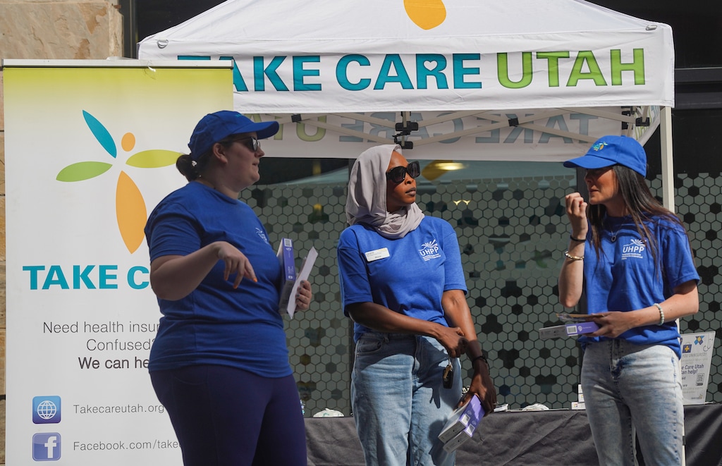 (Bethany Baker | The Salt Lake Tribune file photo) Rebecca Barhorst, left, Mona Taha, center, and Ashley Vaughn, staff with Utah Health Policy Project, worked to educate people about Medicaid and health insurance at the Latinx/Hispanic Health and Heritage Festival in Salt Lake City on Sept. 9, 2023. This month, the state of Utah will start covering children regardless of immigration status, up to a financial cap of about $4.5 million a year.
