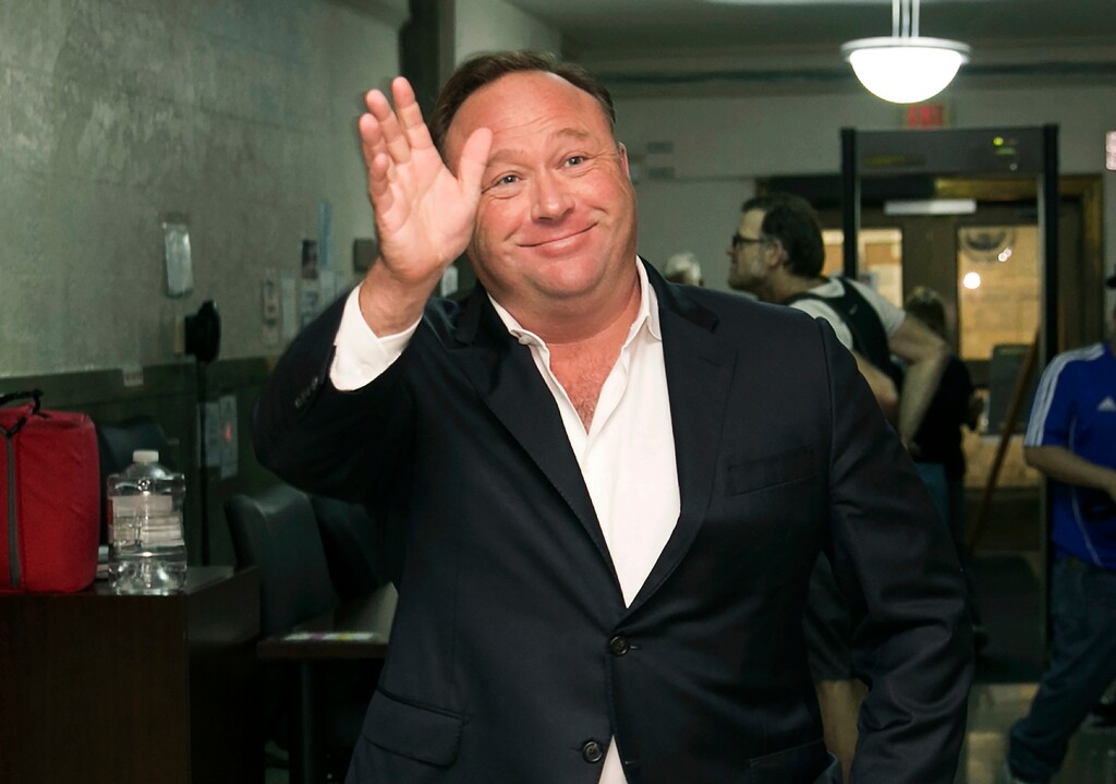 FILE - In this April 19, 2017, file photo, Alex Jones, a right-wing radio host and conspiracy theorist, arrives at the courthouse in Austin, Texas. YouTube, Facebook, Twitter, Spotify and other sites are finding themselves in a role they never wanted, as gatekeepers of discourse on their platforms,  deciding what should and shouldn't be allowed and often angering almost everyone in the process. The latest point of contention is Jones, who has suddenly found himself banned from most major platforms after years of being allowed to use them/. (Jay Janner/Austin American-Statesman via AP, File)