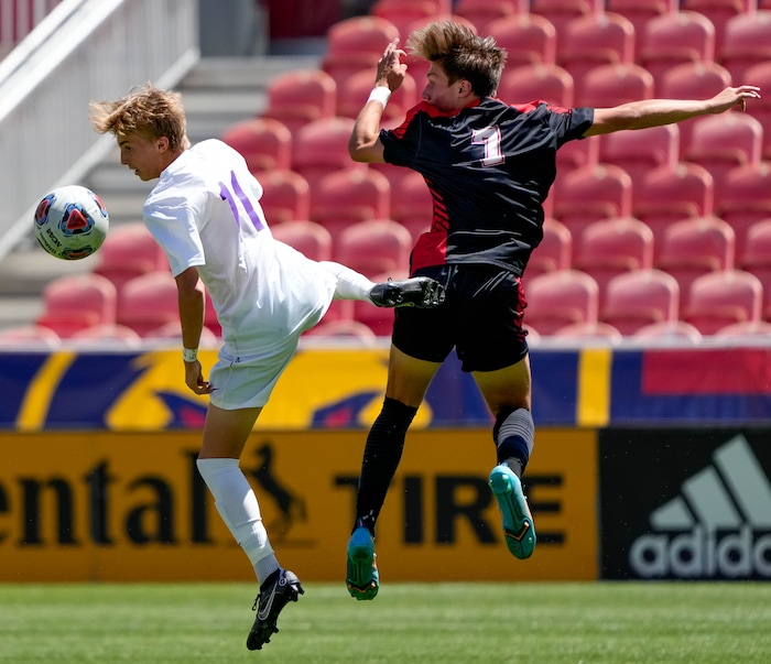 (Francisco Kjolseth | The Salt Lake Tribune) Lehi’s Colton Marsing (11) and Alta’s Jack Johnson (7) go airborne for a header their 5A State Soccer Championship title game at Rio Tinto Stadium, Wednesday, May 25, 2022. Alta defeated Lehi in shootout 3-1.