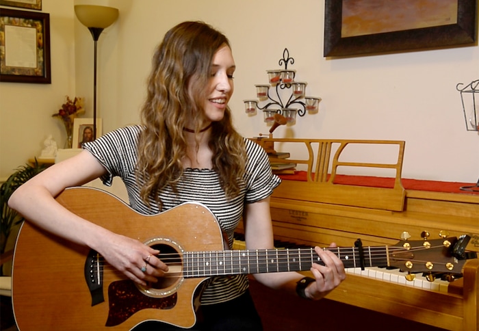(Rick Egan  |  The Salt Lake Tribune)     April Meservy plays the guitar at her home in Provo.  Meservy recorded a cover of U2’s “With or Without You”  with will be used by Canadian pairs figure skaters, Eric Radford, and Meagan Duhamel  as they perform at this year’s Winter Olympic Games in PyeongChang, South Korea. Wednesday, February 7, 2018.


