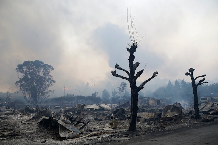 Charred remains sit at Journey's End mobile home park in Santa Rosa, Calif., Monday, Oct. 9, 2017. Wildfires whipped by powerful winds swept through Northern California sending residents on a headlong flight to safety through smoke and flames as homes burned. (AP Photo/Jeff Chiu)