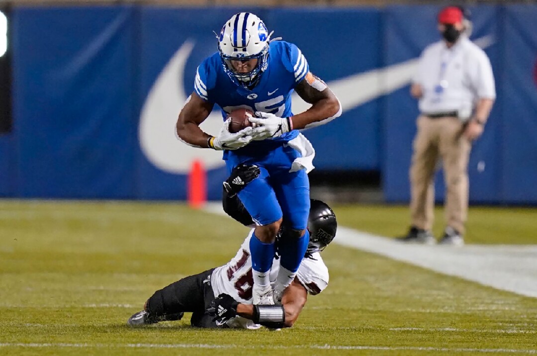 BYU running back Tyler Allgeier (25) is tackled by Troy cornerback Reddy Steward during the first half of an NCAA college football game Saturday, Sept. 26, 2020, in Provo, Utah. (AP Photo/Rick Bowmer, Pool)