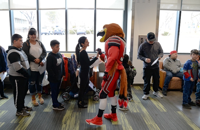 (Francisco Kjolseth  |  The Salt Lake Tribune) Swoop the mascot greets kids lined up with their parents to get free dental care during an outreach program at the University of Utah on Saturday, Feb. 29, 2020, as part of the American Dental AssociationÕs ÒGive Kids a SmileÓ program to help the underserved young.