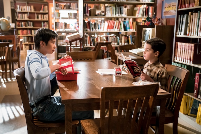 (Photo: Michael Desmond/Warner Bros.) Tam (Ryan Phuong) and Sheldon (Iain Armitage) eat lunch together in the school library on “Young Sheldon.”