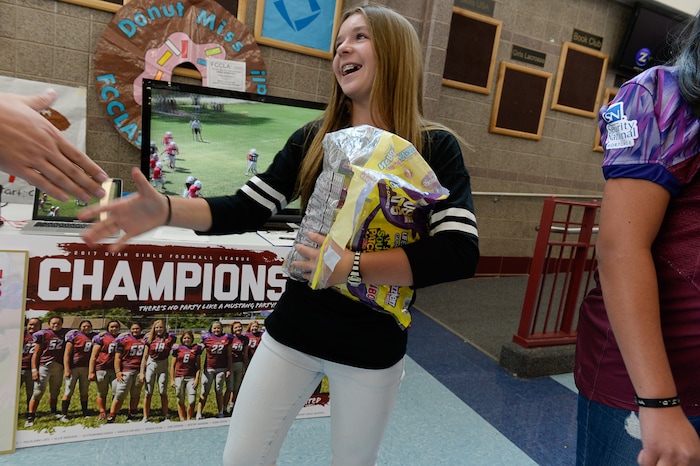 (Francisco Kjolseth | The Salt Lake Tribune) Sam Gordon, 14, works her fellow students at Herriman High School in an effort to sign up girls to play football during a recent clubs sign up day. Brent Gordon and his daughter, Sam, are part of a group suing multiple school districts to try to force the creation of sanctioned girls high school football that would play in the Spring.