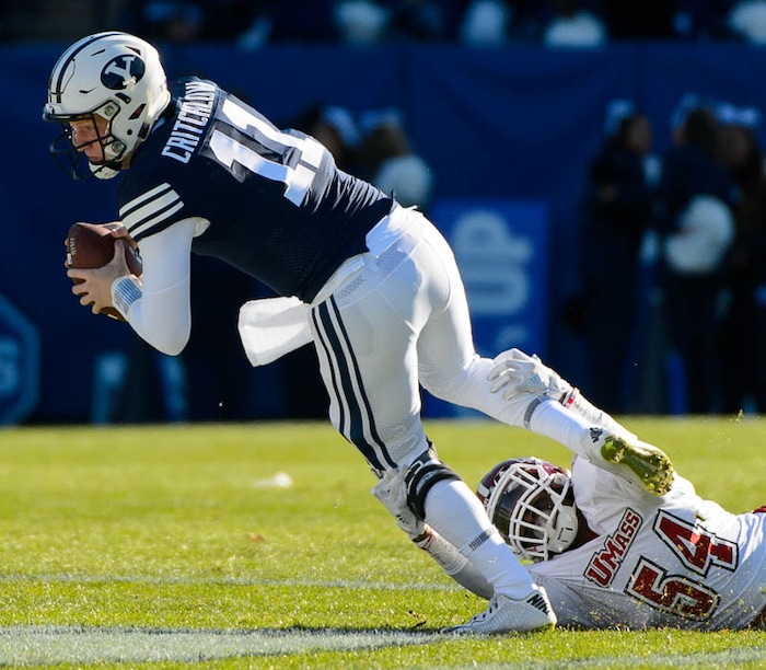 (Trent Nelson | The Salt Lake Tribune)  Brigham Young Cougars quarterback Joe Critchlow (11) is brought down by Massachusetts Minutemen linebacker Leon Flanagan Jr. (54) as BYU hosts the University of Massachusetts, NCAA football in Provo, Saturday November 18, 2017.