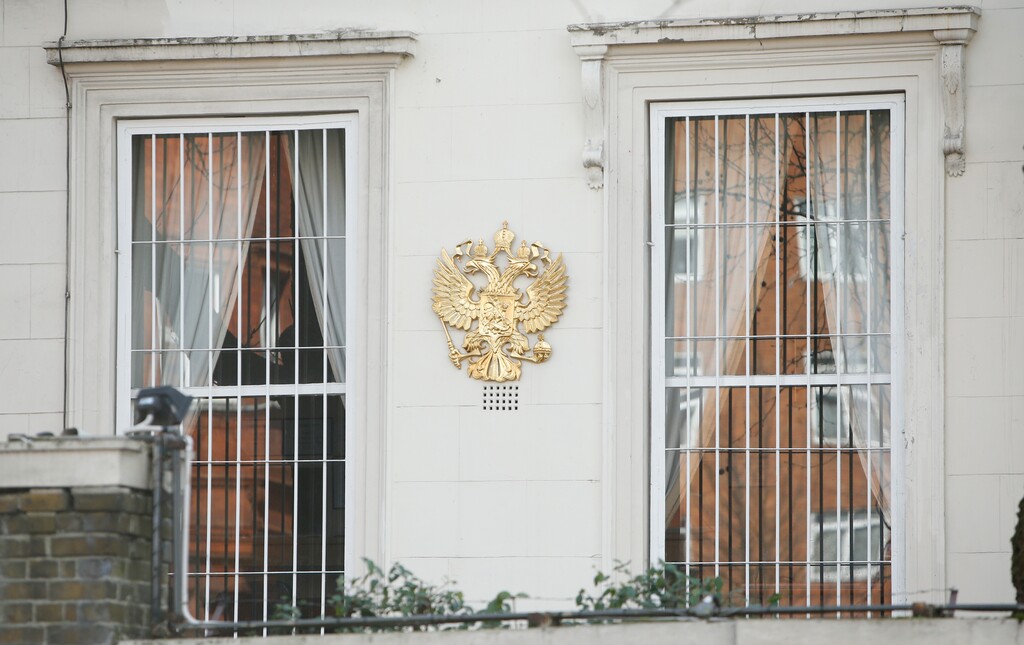 Barred windows with the crest of the Russian Federation at the Russian Embassy in Kensington, London, Wednesday, March 14, 2018.  Britain announced Wednesday it will expel 23 Russian diplomats,  the biggest such expulsion since the Cold War, and break off high-level contacts with the Kremlin over the nerve-agent attack on a former spy and his daughter in an English town. (AP Photo/Alastair Grant)