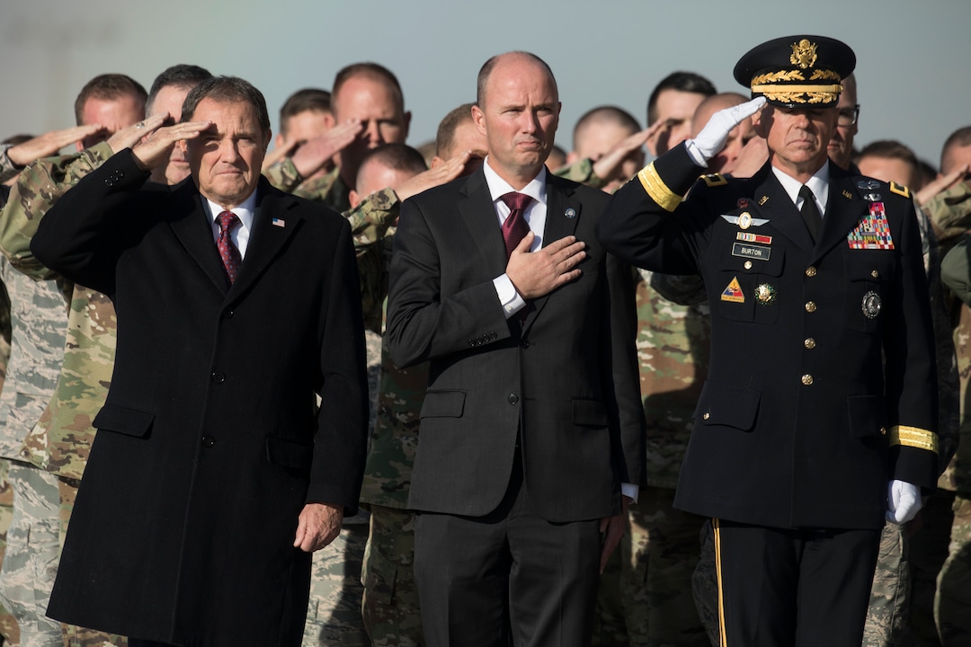(Matt Herp  |  The Ogden Standrad Examiner/Pool) From left, Gov. Gary Herbert, Lt. Gov. Spencer J. Cox, and Maj. Gen. Jefferson S. Burton, salute as members of the Utah National Guard Honor Guard Detail carry a casket containing the remains of Maj. Brent R. Taylor at Roland R. Wright Air National Guard Base in Salt Lake City, Utah, on Wednesday, Nov. 14, 2018. Taylor, 39, of North Ogden, died Nov. 3, 2018, in Afghanistan of wounds sustained from small arms fire. His funeral is scheduled for Saturday, Nov. 17, in Ogden.