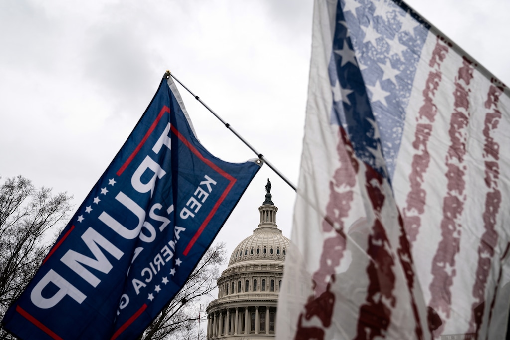 (Erin Schaff | The New York Times)
Supporters of President Donald Trump wave flags as they protest the result of the presidential election in front of the Capitol in Washington on Tuesday, Jan. 5, 2020. "Make all those who have propagated this Big Lie about election fraud to justify voting with Trump and against our Constitution carry the title — “coup plotter” — forever," writes The New York Times columnist Thomas L. Friedman. "If you see them on the street, in a restaurant on your college campus, politely ask them: “You were one of the coup plotters, weren’t you? Shame on you.”