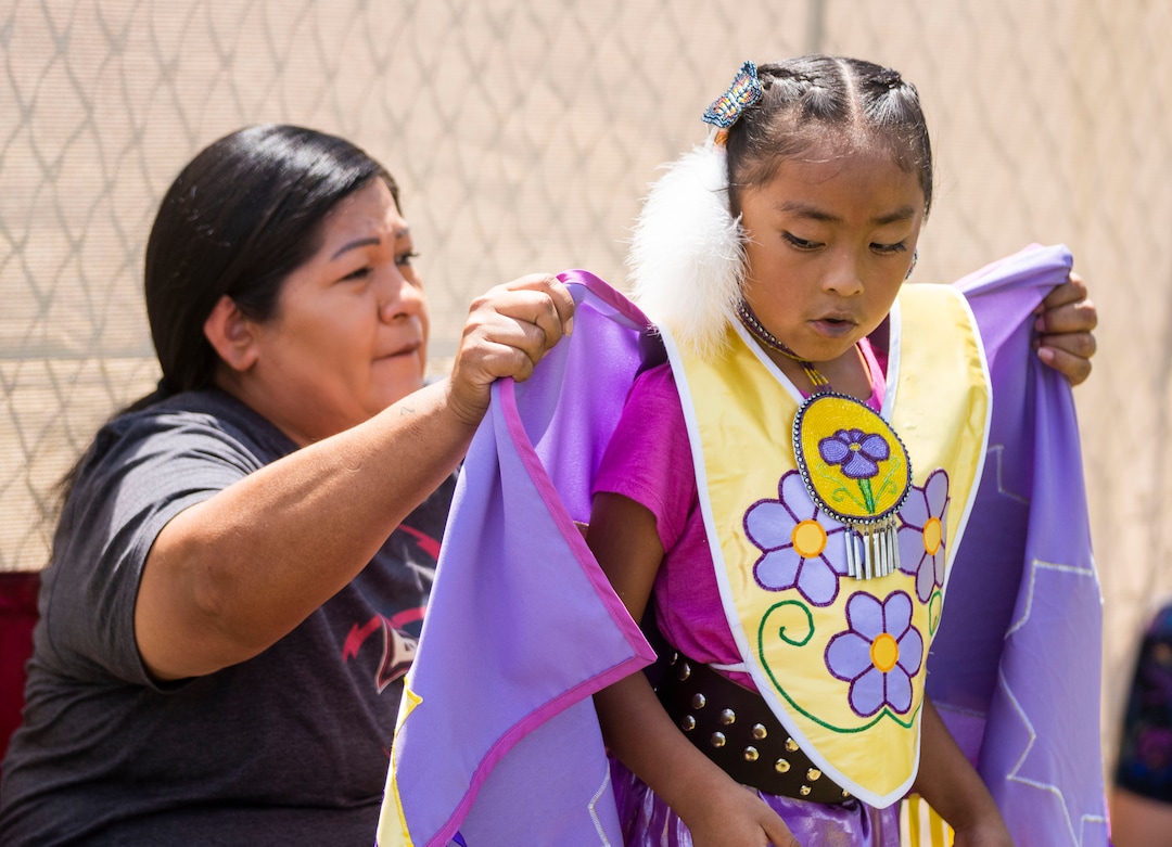 (Rick Egan | The Salt Lake Tribune)  Dalena Serawalk helps eight-year-old daughter, Jorja Taveavont from Fort Duchesne, with her costume, during the Native American celebration and Powwow at Liberty Park, on Friday, July 23, 2021.