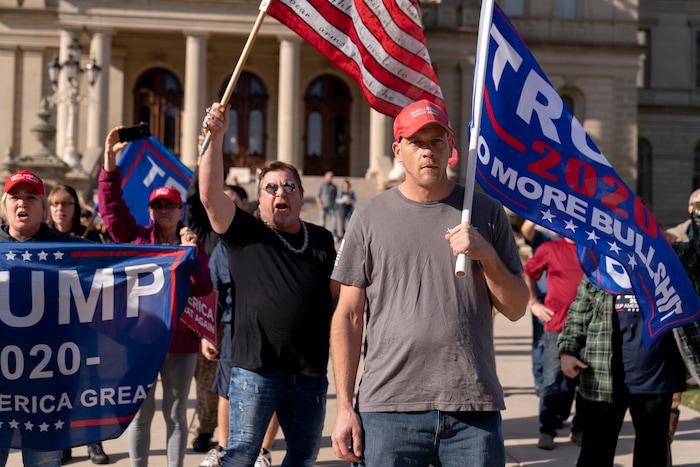 Trump supporters demonstrating the election results face off with counter protesters at the State Capitol in Lansing, Mich., Saturday, Nov. 7, 2020. Democrat Joe Biden defeated President Donald Trump to become the 46th president of the United States on Saturday, positioning himself to lead a nation gripped by the historic pandemic and a confluence of economic and social turmoil. (AP Photo/David Goldman)