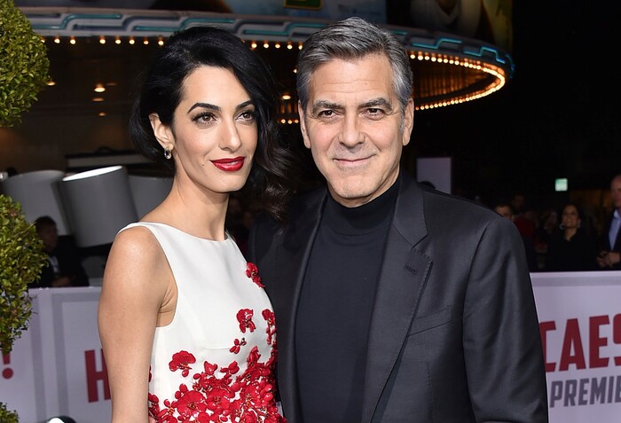 FILE - In this Feb. 1, 2016 file photo, Amal Clooney, left, and George Clooney arrive at the world premiere of "Hail, Caesar!" in Los Angeles. George and Amal Clooney have welcomed twins Ella and Alexander Clooney. The pair was born Tuesday morning, June 6, 2017, according to George Clooney’s publicist Stan Rosenfield. (Photo by Jordan Strauss/Invision/AP, File)