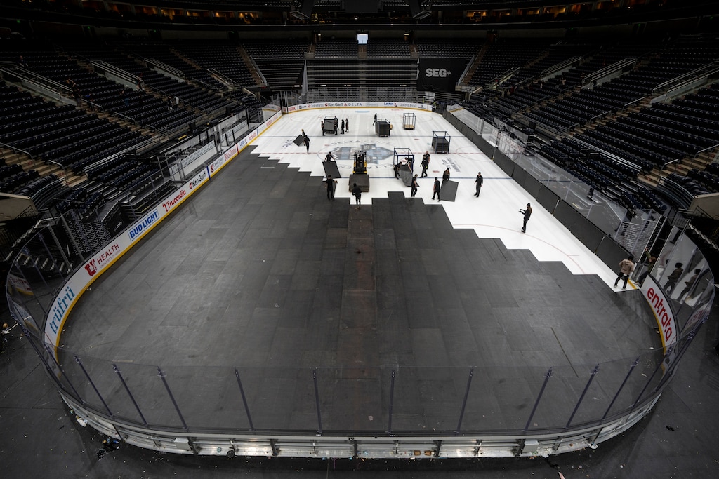 (Rick Egan | The Salt Lake Tribune)  Workers from Show Ready Event Services cover the Ice for the Utah Jazz game tomorrow, after the Utah Hockey Club game on Friday, Dec 27, 2024.