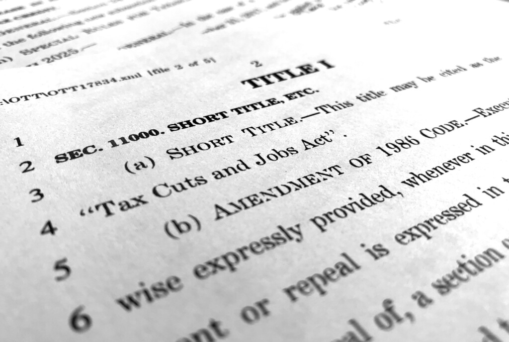 In this Dec. 4, 2017, photo, part of the Republican Senate bill "Tax Cuts and Jobs Act" is photographed in Washington. Republican tax legislation advancing toward final votes in Congress could undermine “Obamacare” health insurance markets, and add to the financial squeeze on Medicare over time. This week lawmakers will try to resolve differences between House and Senate versions in hopes of finishing around Christmas. Also in play are the tax deduction for people with high medical expenses, and a tax credit for drug makers that develop treatments for diseases affecting relatively few patients. (AP Photo/Jon Elswick)