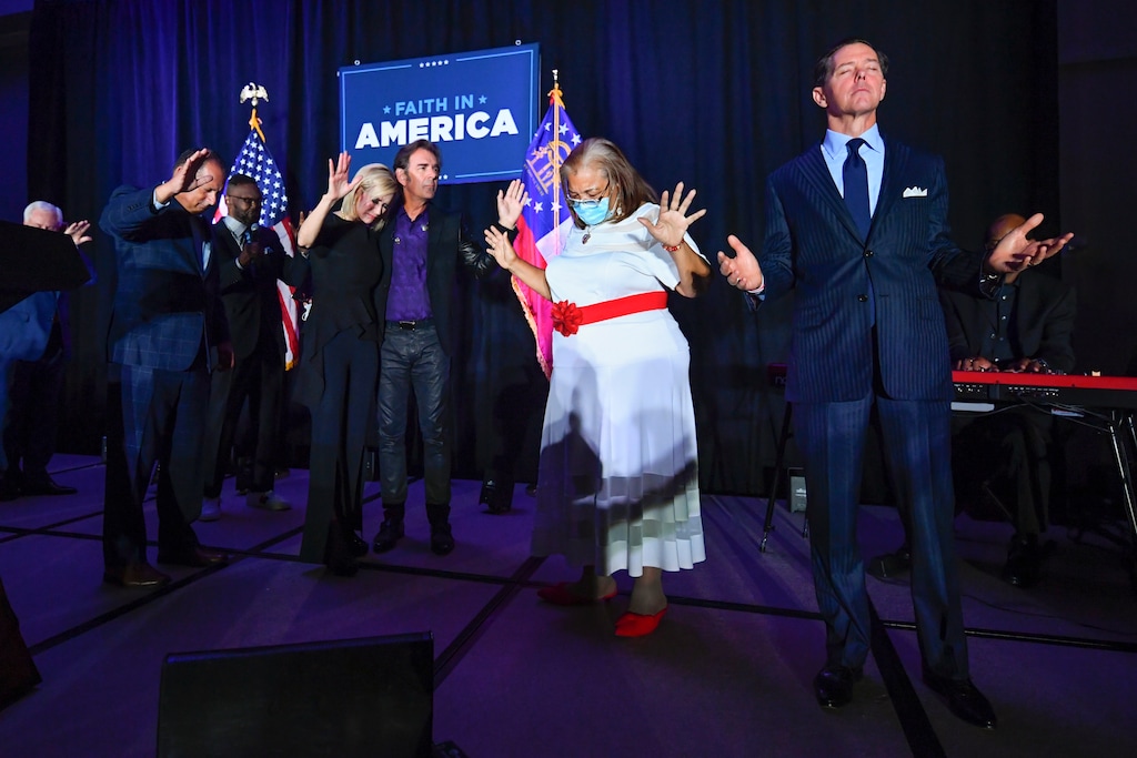 (John Amis | AP file photo)
In this July 23, 2020, photo, from right, Ralph Reed, Dr. Alveda King, Journey keyboardist Jonathan Cain, and personal pastor to the president, Paula White Cain, and others pray on stage during a Donald Trump campaign event courting devout conservatives by combining praise, prayer and patriotism in Alpharetta, Ga.