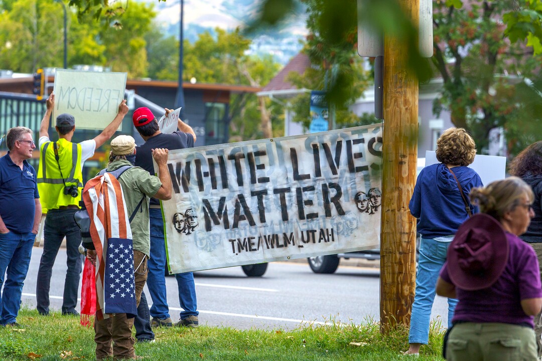 (Leah Hogsten | The Salt Lake Tribune) Protesters waving American flags and holding signs decrying mask and vaccine mandates gathered along the curb of 700 East in Liberty Park Saturday, making Salt Lake City one of dozens of cities around the world protesting public health-related restrictions, Sept. 18, 2021.