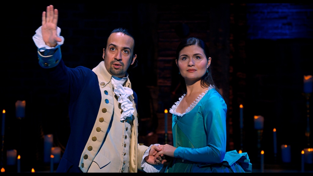 In this image released by Disney Plus, Lin-Manuel Miranda portrays Alexander Hamilton, left, and Phillipa Soo portrays Eliza Hamilton in a filmed version of the original Broadway production of "Hamilton." (Disney Plus via AP)