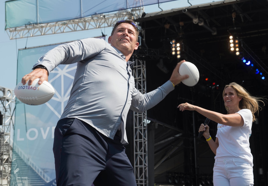 (Rick Egan  |  The Salt Lake Tribune)     Steve Young tosses footballs in to the crowd with the assistance of his wife Barb, at the Loveloud Festival at Rice-Eccles Stadium, Saturday, July 28, 2018.