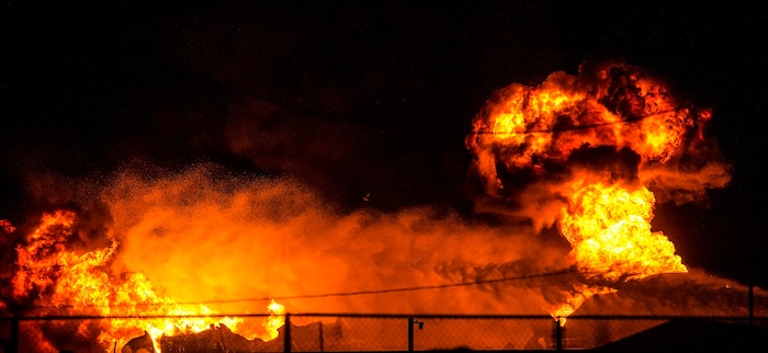 (Chris Detrick  |  The Salt Lake Tribune)  Firefighters attempt to put out a burning semitrailer that was hauling thousands of gallons of fuel on Interstate-15 in Midvale Thursday, January 18, 2018.   Lt. Todd Royce of the Utah Highway Patrol said the truck was southbound on the interstate at 7500 South at 7:20 p.m. when a tire caught fire, sending flames toward the tanks.
