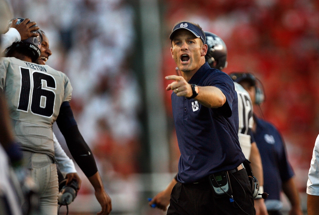 Scott Sommerdorf   |  The Salt Lake TribuneAs USU QB Chuckie Keeton gets congratulations on the sideline for his TD toss to give USU a 17-14 halftime lead over Utah, head coach Matt Wells gets his sideline prepared for the PAT, Thursday, August 29, 2013.