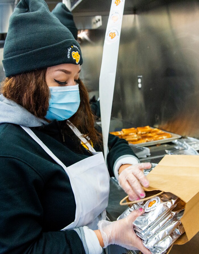 (Rick Egan | The Salt Lake Tribune)  Lissette Torres bags grilled cheese sandwiches for 600 health care workers as part of the the Curds + Kindness program, which supports local dairy farmers, at the South Jordan Health Center in Daybreak on Tuesday, Dec. 1, 2020.