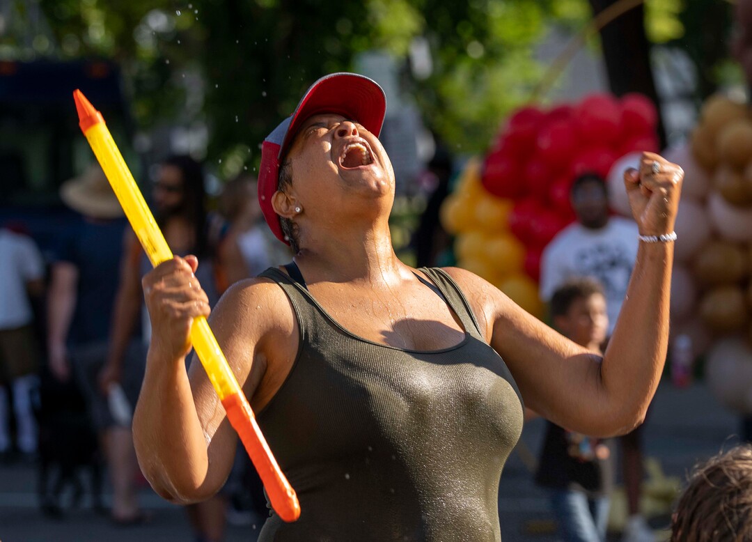 (Rick Egan | The Salt Lake Tribune) Lex Scott, the Founder of Black Lives Matter Utah, celebrates after squirting a young Juneteenth reveler, during a water fight during the Juneteenth celebration, on  Saturday, June 19, 2021.