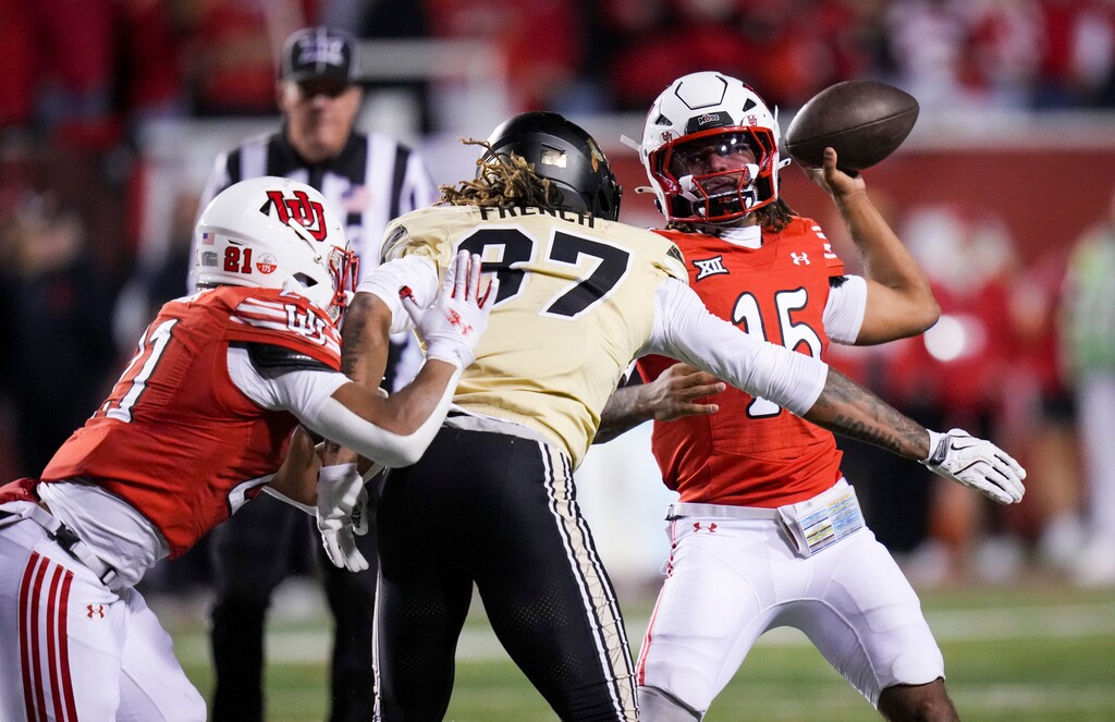 (Bethany Baker  |  The Salt Lake Tribune) Utah Utes quarterback Byrd Ficklin (15) passes the ball as Utah Utes running back Naquari Rogers (21) blocks Colorado Buffaloes linebacker Martavius French (37) during the game between the Utah Utes and the Colorado Buffaloes at Rice-Eccles Stadium in Salt Lake City on Saturday, Oct. 25, 2025.