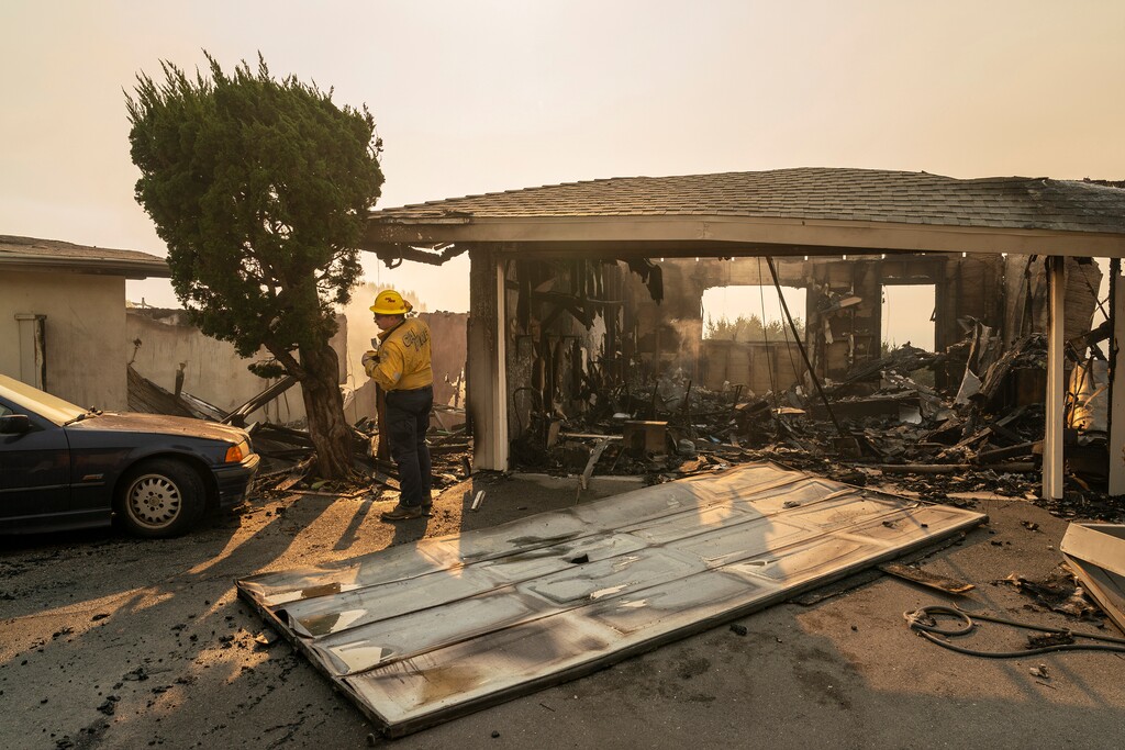 (Loren Elliott | The New York Times) A firefighter from Cal Fire looks for hotspots amid the rubble of a home in the wake of the Palisades fire in the Pacific Palisades neighborhood of Los Angeles, on Thursday, Jan. 9, 2025. 