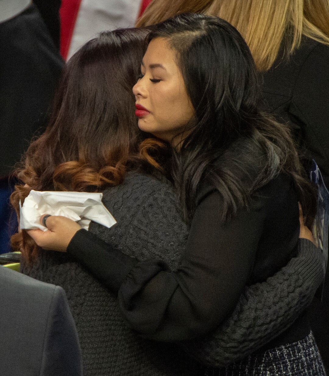 (Rick Egan  |  The Salt Lake Tribune)     Elizabeth Romrell, wife of South Salt Lake police officer, David Romrell gets a hug, before the funeral at the Maverik Center, in West Valley City, Wednesday, Dec. 5, 2018.