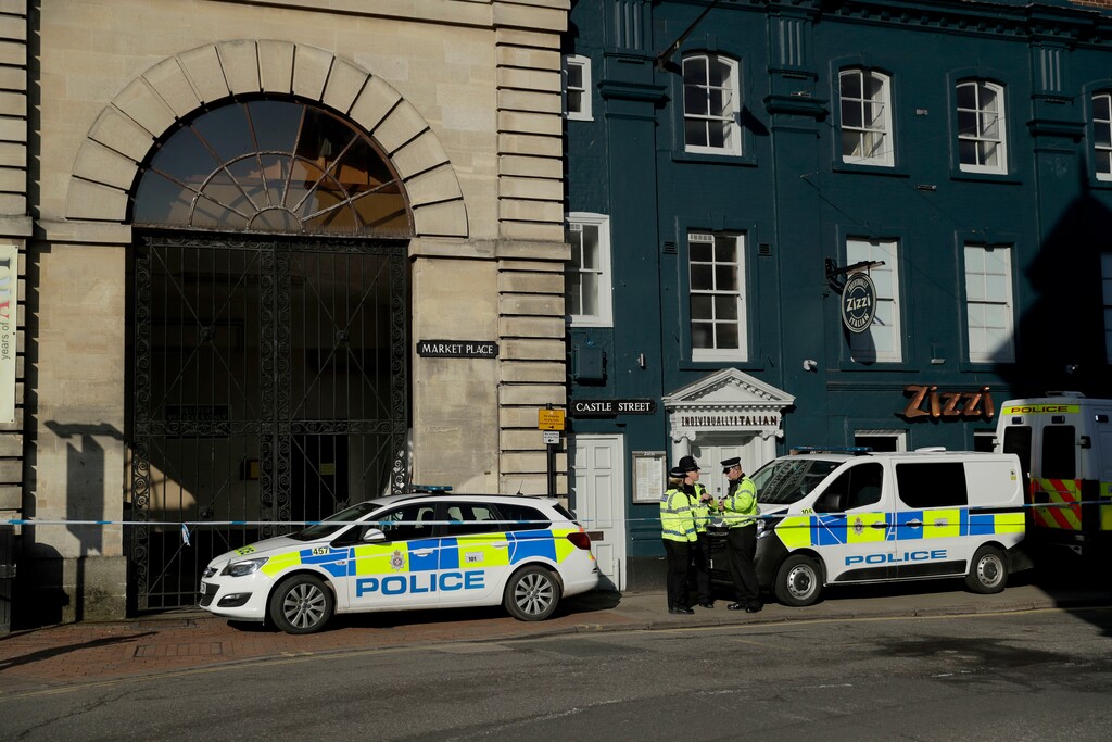 Police officers stand outside a Zizzi restaurant in Salisbury, England, Wednesday, March 7, 2018, near to where former Russian double agent Sergei Skripal was found critically ill. Britain's counterterrorism police took over an investigation Tuesday into the mysterious collapse of the former spy and his daughter, now fighting for their lives. The government pledged a "robust" response if suspicions of Russian state involvement are proven. Sergei Skripal and his daughter are in a critical condition after collapsing in the English city of Salisbury on Sunday. (AP Photo/Matt Dunham)