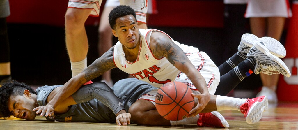 (Steve Griffin  |  The Salt Lake Tribune) Arizona State Sun Devils guard Remy Martin (1) crashes to the court as Utah Utes guard Justin Bibbins (1) scoops up the ball during the Utah Utes versus Arizona State Sound Devils at the Huntsman Center on the University of Utah campus in Salt Lake City Sunday January 7, 2018.