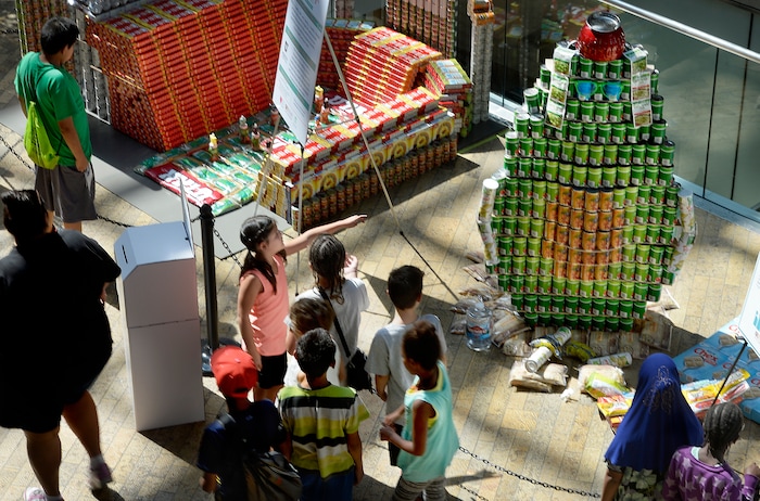 (Scott Sommerdorf | The Salt Lake Tribune) Visitors to the Salt Lake City Public Library look at the Molina Healthcare avocado built from canned food as the library hosted a community display and food drive focused on healthy food items for the Utah Food Bank. Teams from six local health careÐrelated businesses built giant sculptures using healthy canned, bagged, and boxed foods. The replica of Rice-Eccles Stadium, above/left, won the public choice award, Thursday, August 10, 2017.