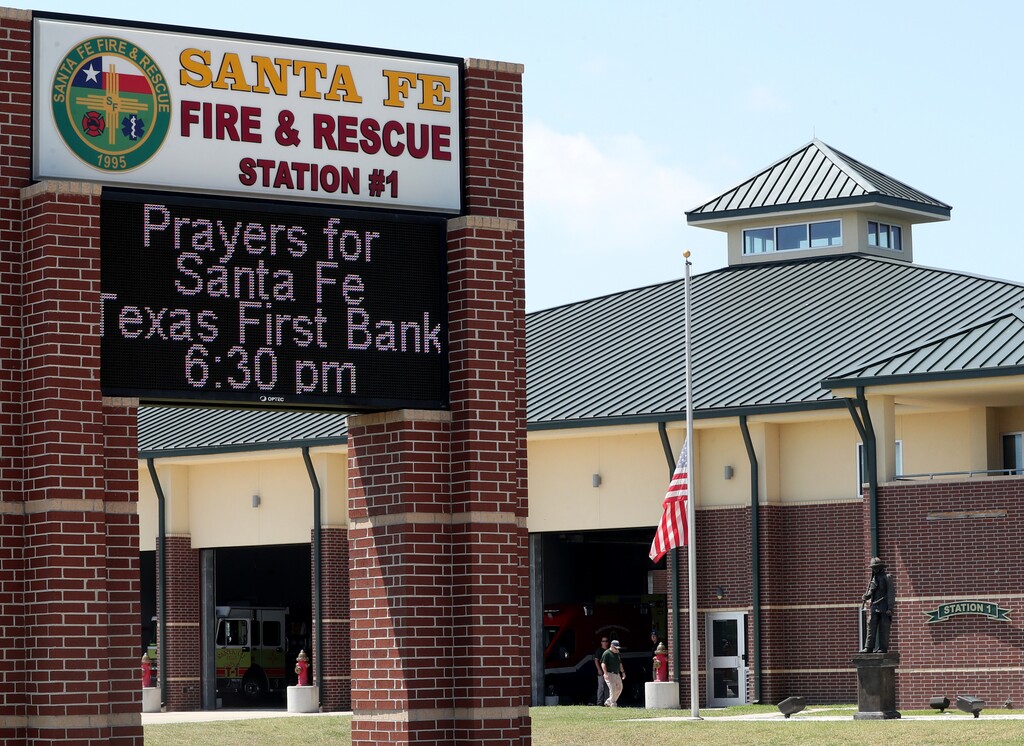 (Jennifer Reynolds/The Galveston County Daily News via AP) A marquee at the Santa Fe Volunteer Fire Department announces the time and location for a vigil for the Santa Fe High School shooting victims Friday, May 18, 2018 in Santa Fe, Texas.