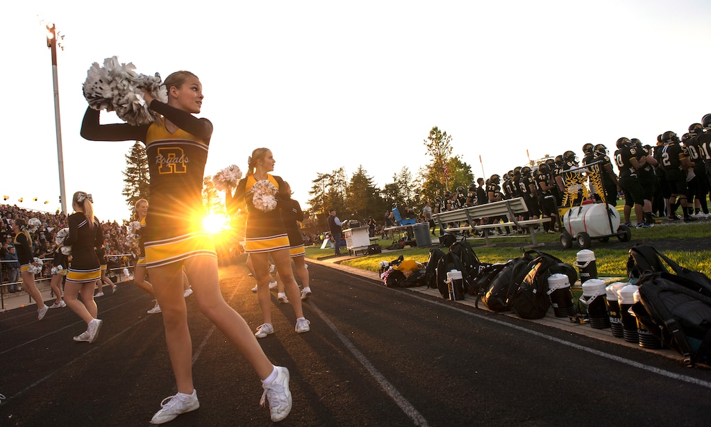 (Leah Hogsten | The Salt Lake Tribune file photo) Roy High School cheerleader Libbie Miles looks to the field as the Royals crowd roars during a game in 2016. A new audit has shown that Utah schools around the state are charging students excessive dues to participate in sports and extracurricular clubs, such as cheerleading.