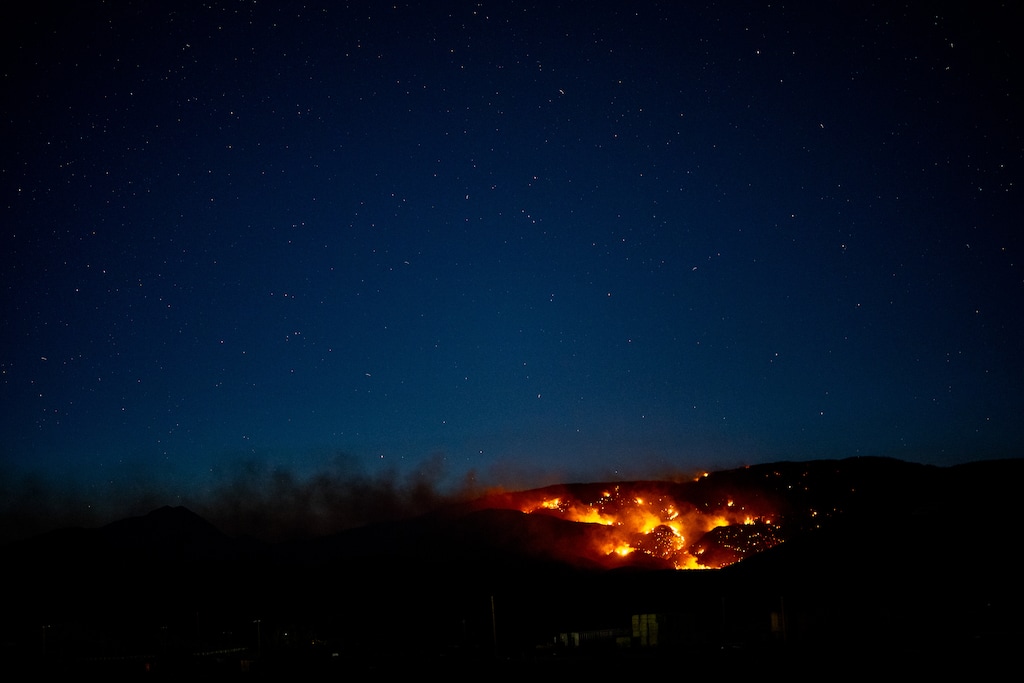 (Trent Nelson  |  The Salt Lake Tribune) The Cottonwood Fire burns above Beaver before sunrise on Friday, June 26, 2026.