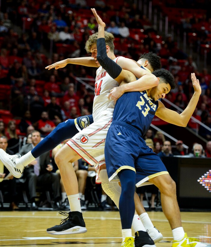 (Steve Griffin  |  The Salt Lake Tribune)  Utah Utes forward Jayce Johnson (34) battles UC Davis Aggies forward A.J. John (25) and UC Davis Aggies guard Rogers Printup (23) during the Utah versus UC Davis men's NIT basketball game at the Huntsman Center in Salt Lake City Wednesday March 14, 2018.