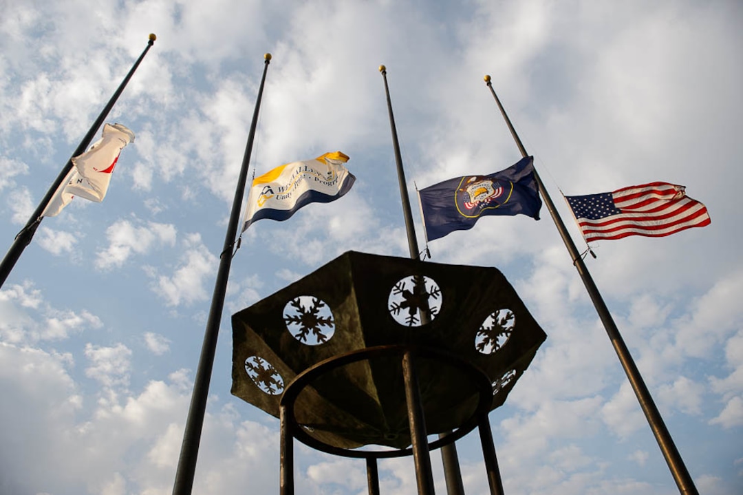(Trent Nelson | The Salt Lake Tribune)  Flags fly at half mast at the funeral services for Battalion Chief Matthew Burchett at the Maverik Center in West Valley City, Monday Aug. 20, 2018.