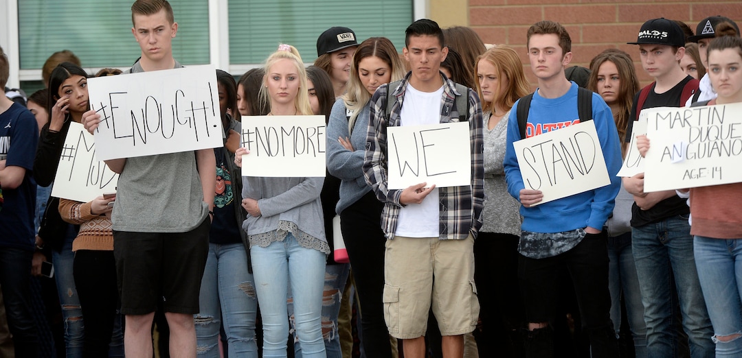 (Al Hartmann  |  The Salt Lake Tribune) 	About 80 students at Westlake High School in Saratoga Springs left class and stood together in silence at the front entrance of the school Wednesday March 14, 2018 to remember the 17 students who died in a school shooting in Florida.  They held posters of the names of those killed. 