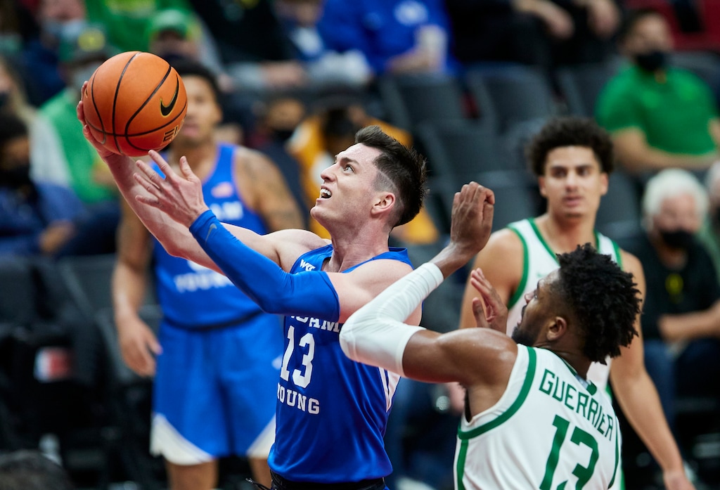 (Craig Mitchelldyer | AP) BYU guard Alex Barcello, left, shoots next to Oregon forward Quincy Guerrier in November. Barcello's 15 points helped pace BYU against Pacific to open West Coast Conference play on Thursday.